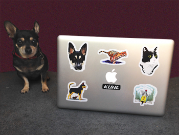 Dog posing with Redbubble stickered MacBook Pro laptop
